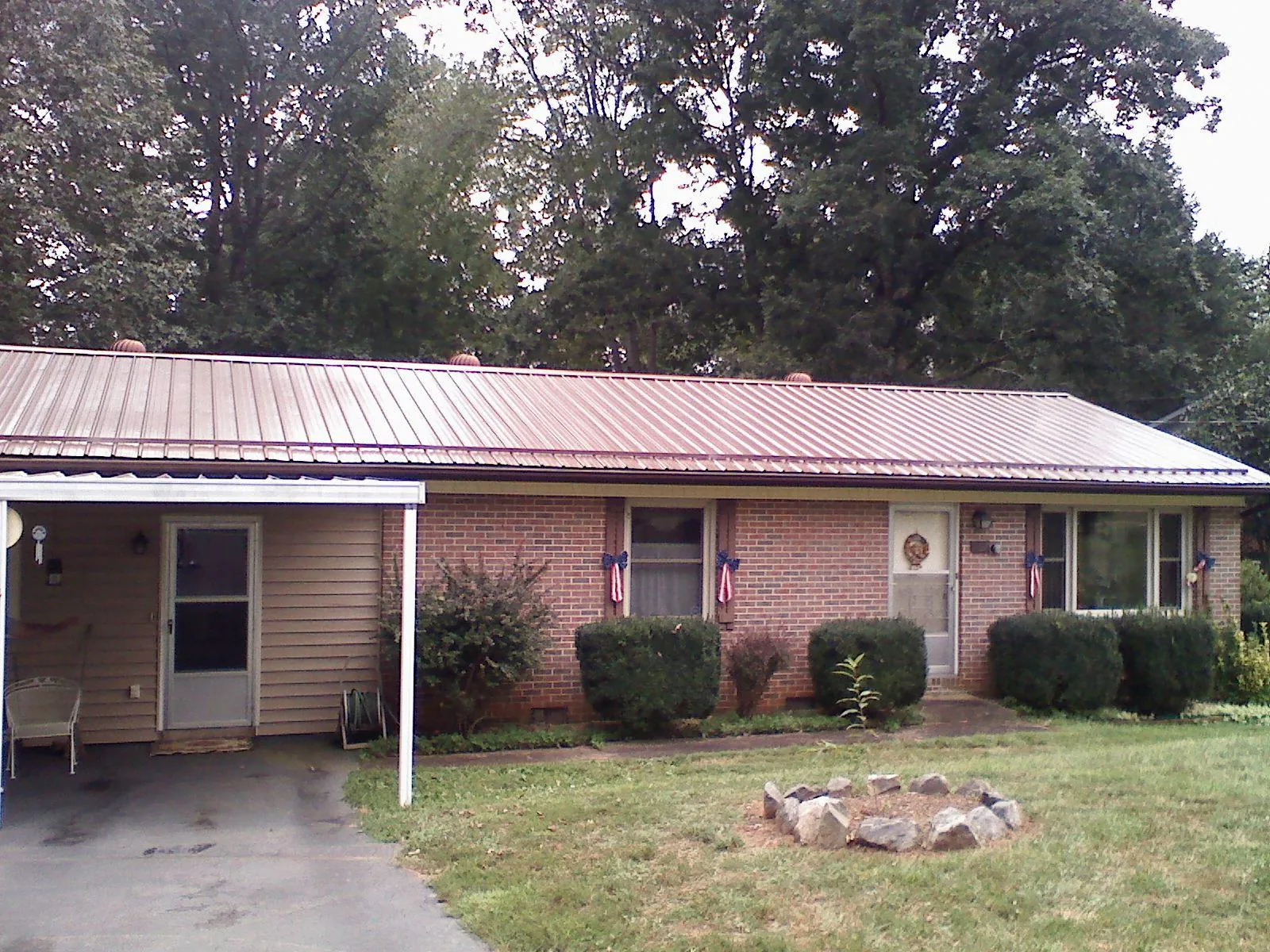 Bronze metal roof and carport on a brick ranch home — Roof Repair work by our crew in Turtletown